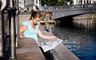 Copenhagen: A woman sitting by the canals of Copenhagen enjoying the sunshine. 
Photographer: Ty Stange. 
For terms of use please visit http://www.copenhagenmediacenter.com/